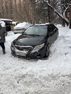 Застряли в сугробе похоже 
Переднее колесо водительское прокручивается 
Похоже села днищем на снег
Ни назад ни вперед толкали не едет 
Только буксир 
Еще не могу багажник открыть а там для буксировки болт вытащить застрявшую машину Тойота королла
